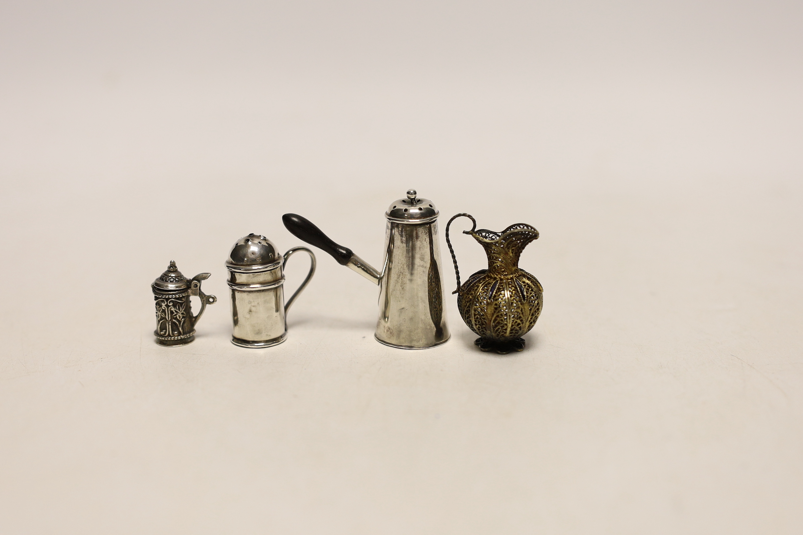 A late Victorian miniature silver chocolate pot, Saunders & Shepherd, Chester, 1894, 42mm, a miniature silver kitchen pepper, miniature tankard and filigree jug.